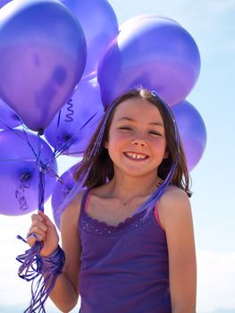 Pretty little girl with baloons in hand