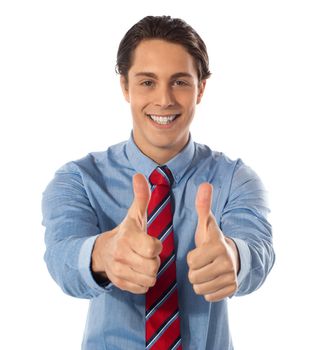 Handsome male executive gesturing thumbs-up