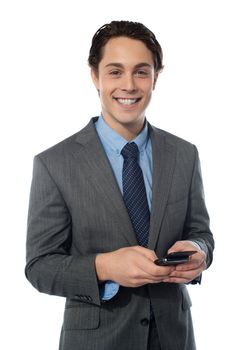 Handsome businessman using a smartphone isolated on white