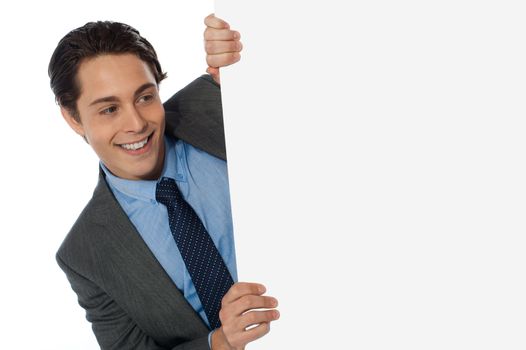 Businessman looking around the corner isolated on white background