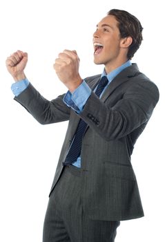 Excited successful businessman with arms raised in success