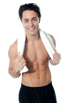 Handsome muscular man with the towel after completing his workout