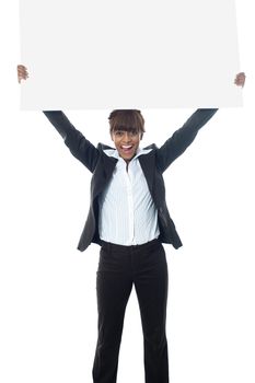 Excited businesswoman poisng with billboard isolated on white