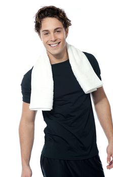 Handsome muscular man with towel around his neck over white background