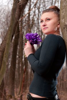 beautiful girl with snowdrops in a forest