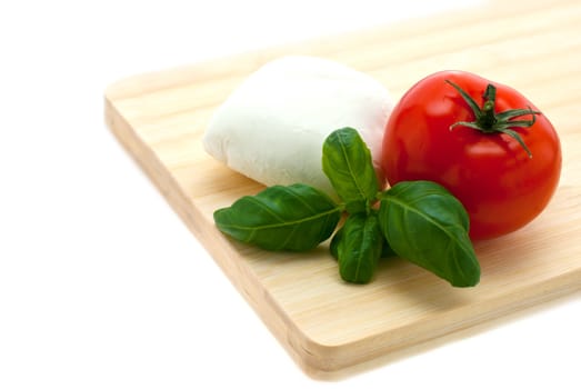 mozzarella, basil, tomatoes lying on the board