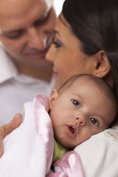 Happy Young Attractive Mixed Race Family with Newborn Baby.