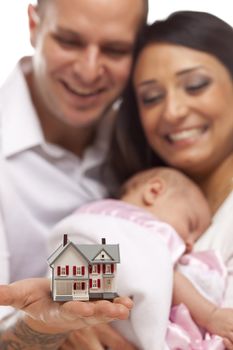 Young Attractive Happy Mixed Race Family with Baby and Small Model House.