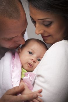 Happy Young Attractive Mixed Race Family with Newborn Baby.