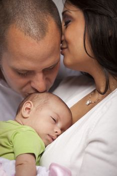 Happy Young Attractive Mixed Race Family with Newborn Baby.