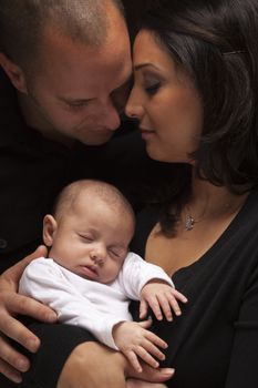 Happy Young Attractive Mixed Race Family with Newborn Baby.