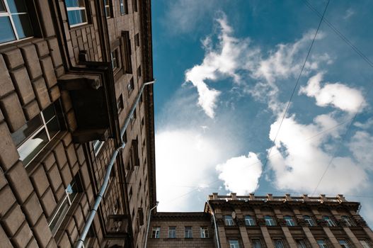 Old residential house wide angle view with clouds on background