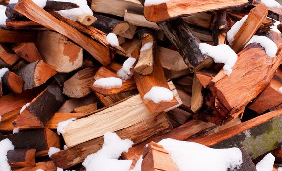 pile of wood covered with white snow