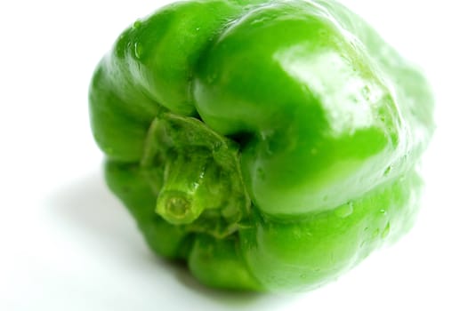 Closeup view of fresh green pepper on a white background