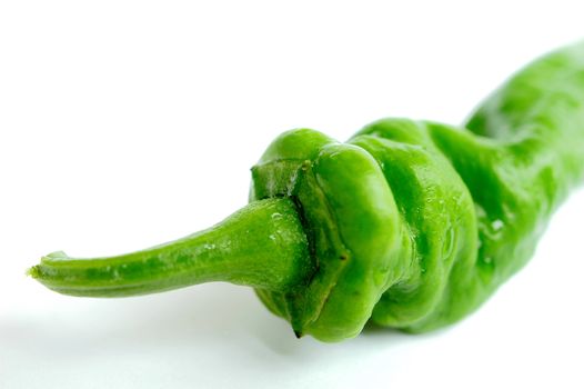 Closeup view of fresh green pepper on a white background