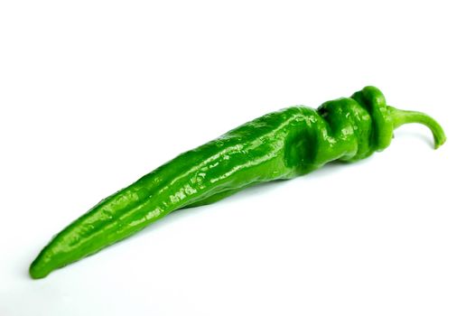 Closeup view of fresh green pepper on a white background