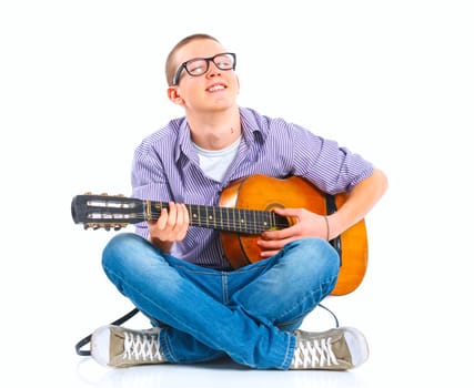 Cute boy sitting with classical guitar. Isolated on white background