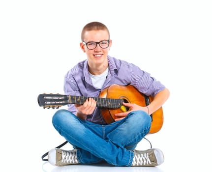 Cute boy sitting with classical guitar. Isolated on white background