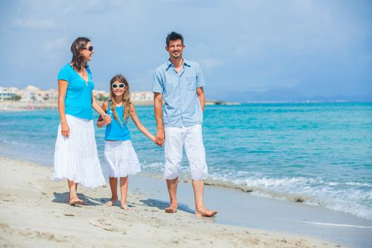 Family of three having fun on tropical beach