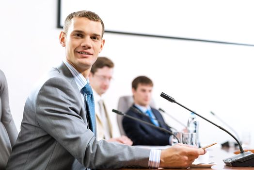 Portrait of a businessman, in the background colleagues communicate with each other