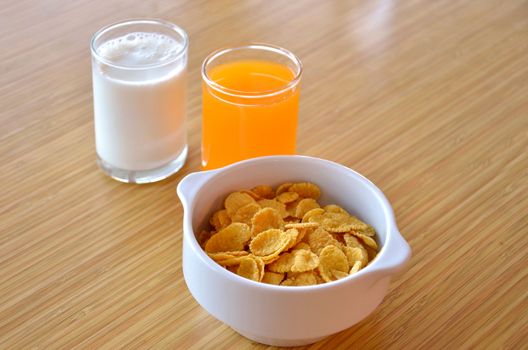 delicious cornflaskes,  white  milk  and orange juice