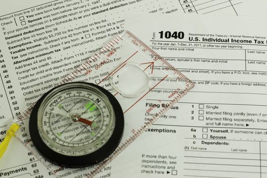 tax form with a compass, guidance concept