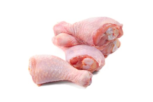 Four fresh raw chicken legs isolated on white background