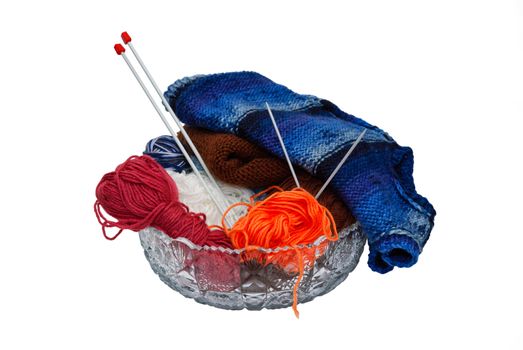 Balls of wool and knitting needles in vase isolated on a white background