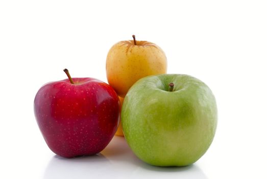 Red, green and yellow apples with reflection