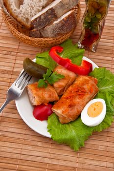 Stuffed cabbage on plate, fork and bread
