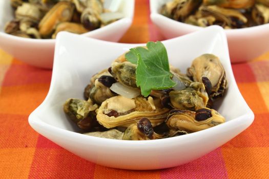 a bowl of marinated mussels and parsley