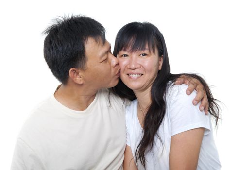 Loving Mature Asian couple kissing on white background