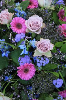 Mixed floral arrangement in purple, pink and blue, roses and gerberas