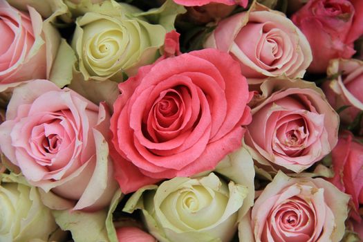 Detail of a wedding centerpiece, different shades of pink roses