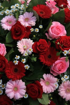 gerberas and roses in a red and pink mixed flower arrangement