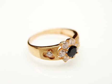 Yellow gold ring with black gemstone, towards white