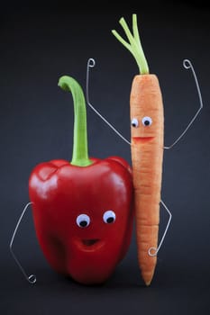 Character made ​​with vegetables. Carrot and bell pepper with eyes and arms