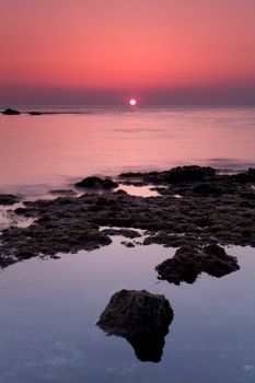 Red sunrise at Cap d'Antibes in south of France.