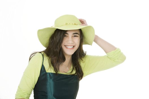 Smiling teen  biracial girl in green dress and lime green hat