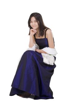 Young teen biracial girl in elegant, dark blue dress gown isolated on white