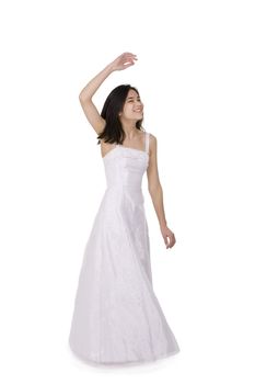 Beautiful young teen girl in white dress or gown twirling, isolated on white