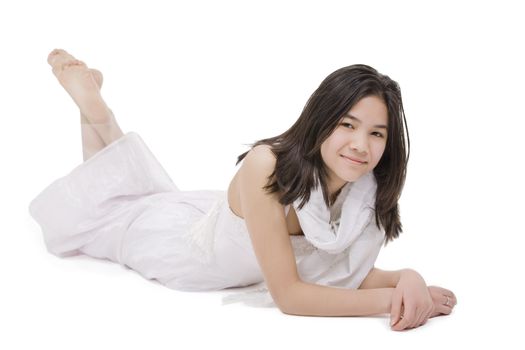 Beautiful young teen girl in white dress or gown lying down, isolated on white