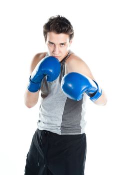 A young boxer in gray shirt and blue boxing gloves