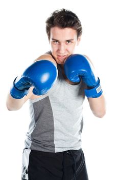 A young boxer in gray shirt and blue boxing gloves