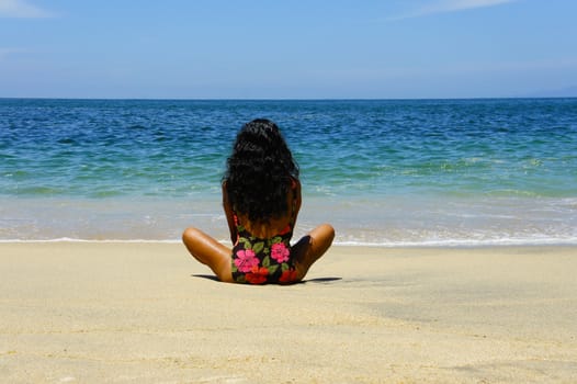 Latin Woman relaxing at a tropical beach