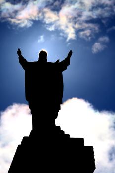 backlight of statue of Jesus Christ giving the blessing