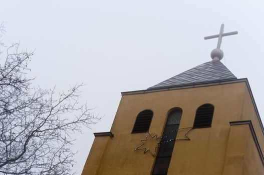Church in the fog with star and cross
