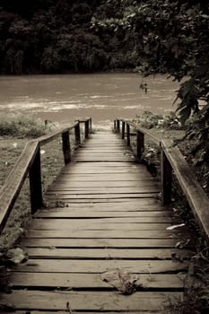 Old wooden bridge in old style photo in portrait orientation