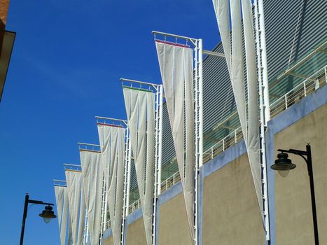 triangular white flags on poles against blue sky