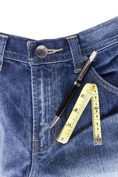 Pen and measuring tape on jeans